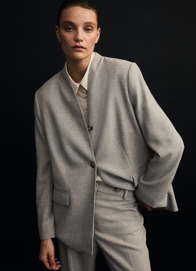 model wearing Lapelless blazer in grey with matching grey trousers