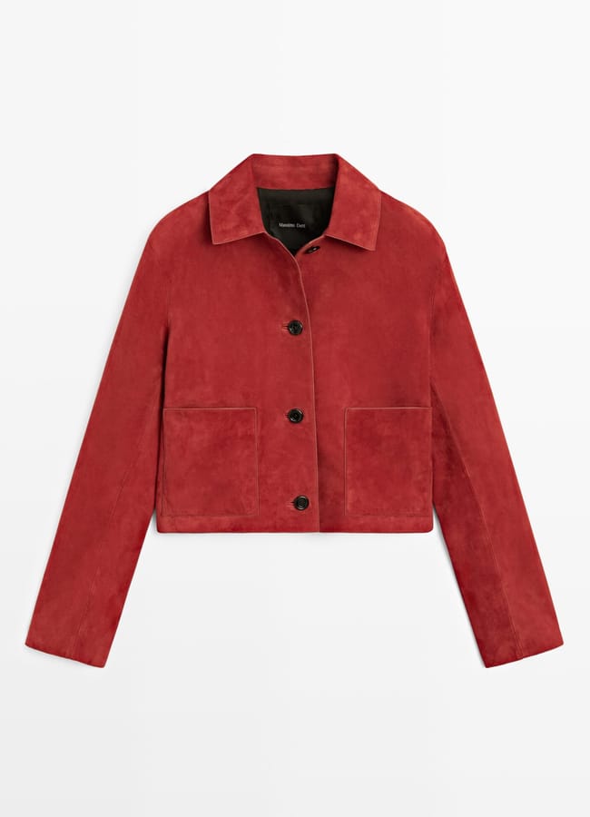 A women’s cropped suede jacket in deep red, featuring a collar, front button fastening, and two large front pockets—an ideal addition to any Wuthering Heights wardrobe. Laid flat on a white background.