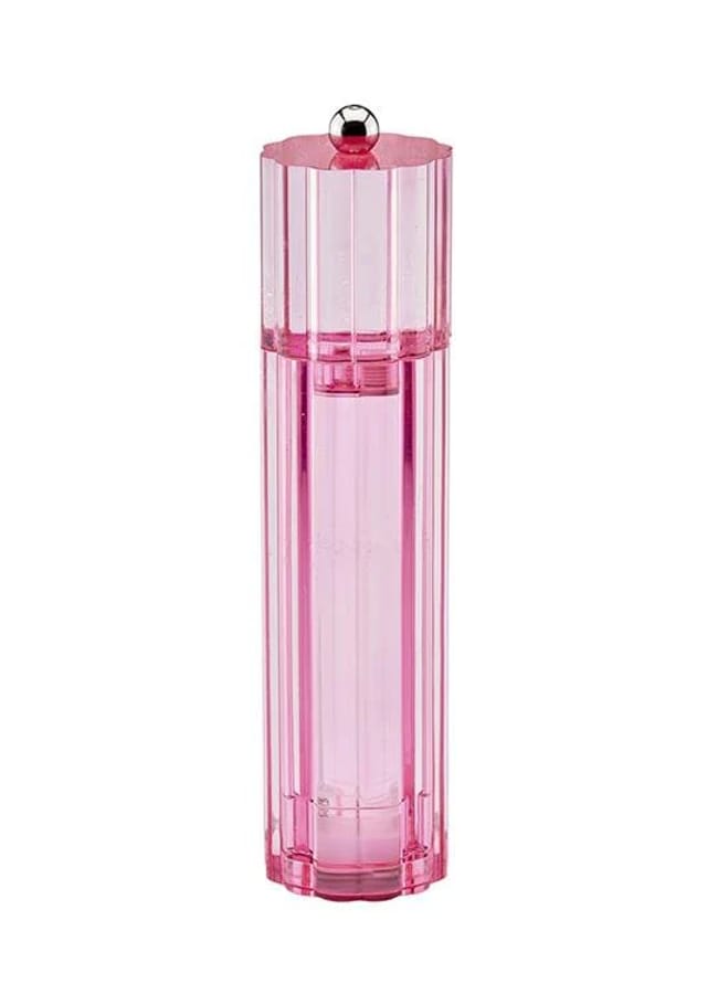 A tall, cylindrical pink perfume bottle with a faceted design and a silver ball on top stands upright against a white background, complementing red and pink interiors beautifully.
