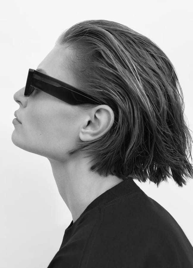 model from side wearing black sunglasses