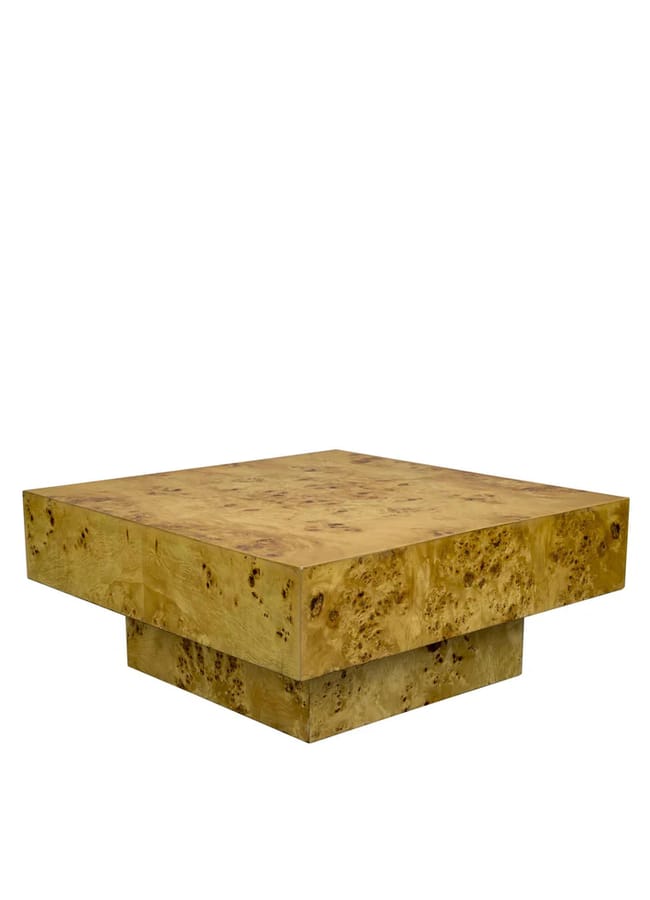 A square, low-profile coffee table made of light-coloured, burled wood with a thick top and a wide, sturdy base.