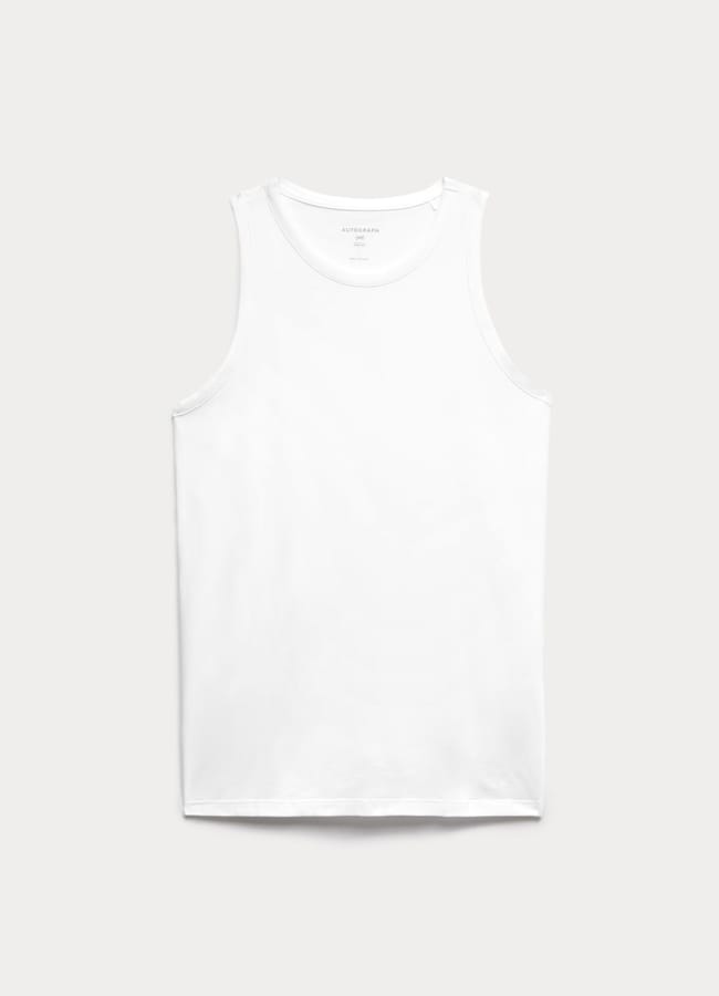 A plain white sleeveless vest is laid flat against a light grey background. The vest has a round neckline and simple, seamless design with no visible logos or patterns—perfect for effortless Casual Date Night Looks.