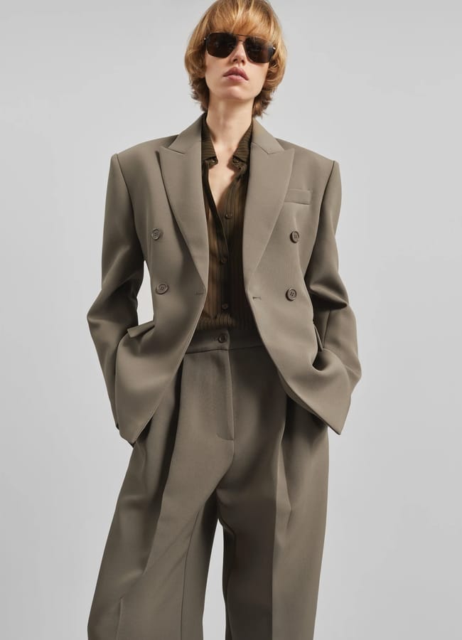 A person in a suit, channelling a Wuthering Heights wardrobe, exudes classic elegance with a hint of timeless romance.