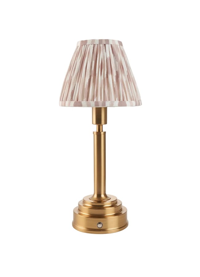 Table lamp with a gold metal base and a pleated fabric lampshade in light pink and white stripes, styled for chic high street homeware, standing upright against a white background.