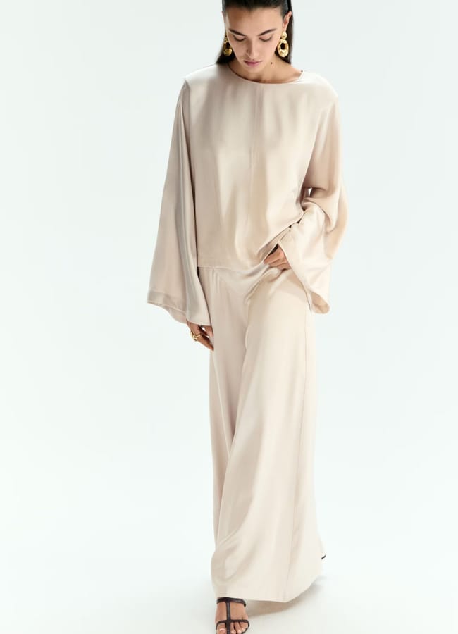 MODEL WEARING Wide-leg trousers AND MATCHING TOP IN CREAM SILK
