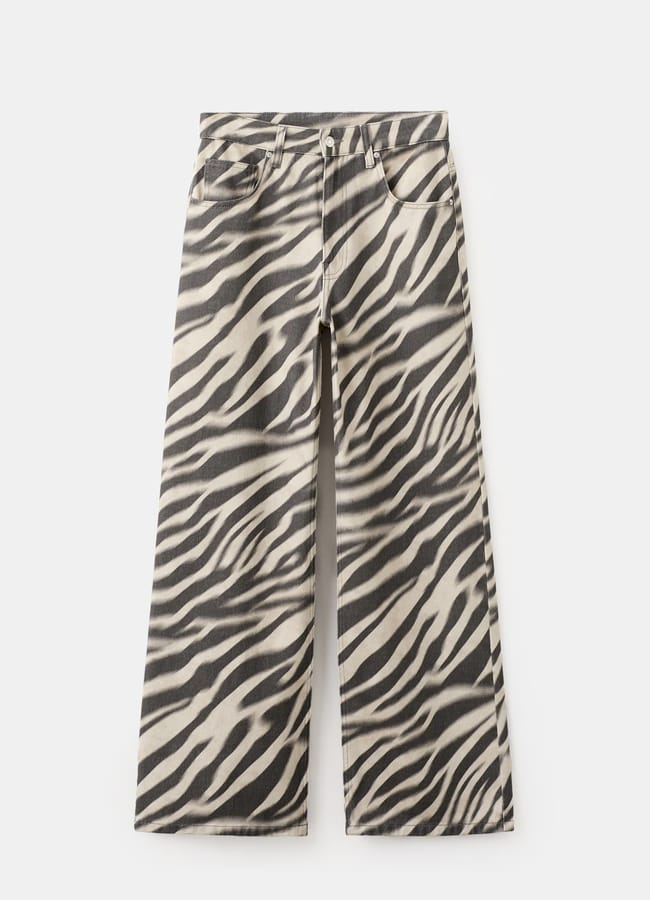 Wide-leg trousers with a high waist and bold zebra print, featuring front and back pockets, are displayed against a white background.