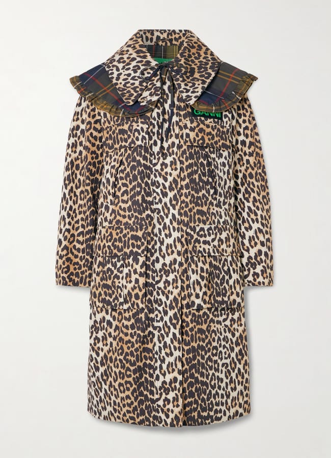 A long leopard-print coat with large pockets, 3/4 sleeves, and a wide, ruffled plaid collar in dark colours. This stylish waterproof jacket features a modern, eclectic design mixing animal and tartan patterns for a bold statement look.