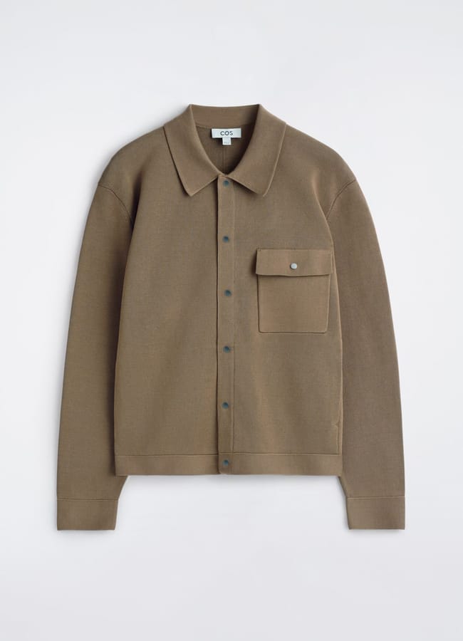 A brown button-up shirt with a pointed collar, long sleeves, and a single chest pocket with a flap, laid flat on a white background—an ideal layering piece to pair with your favourite men's jackets.