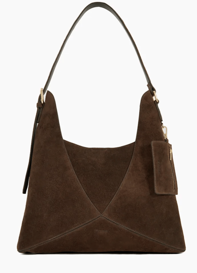 A brown suede hobo handbag with a single shoulder strap, gold-tone hardware, and a matching attached pouch on the side—perfect to recreate outfits or find Instagram dupes—displayed against a plain white background.