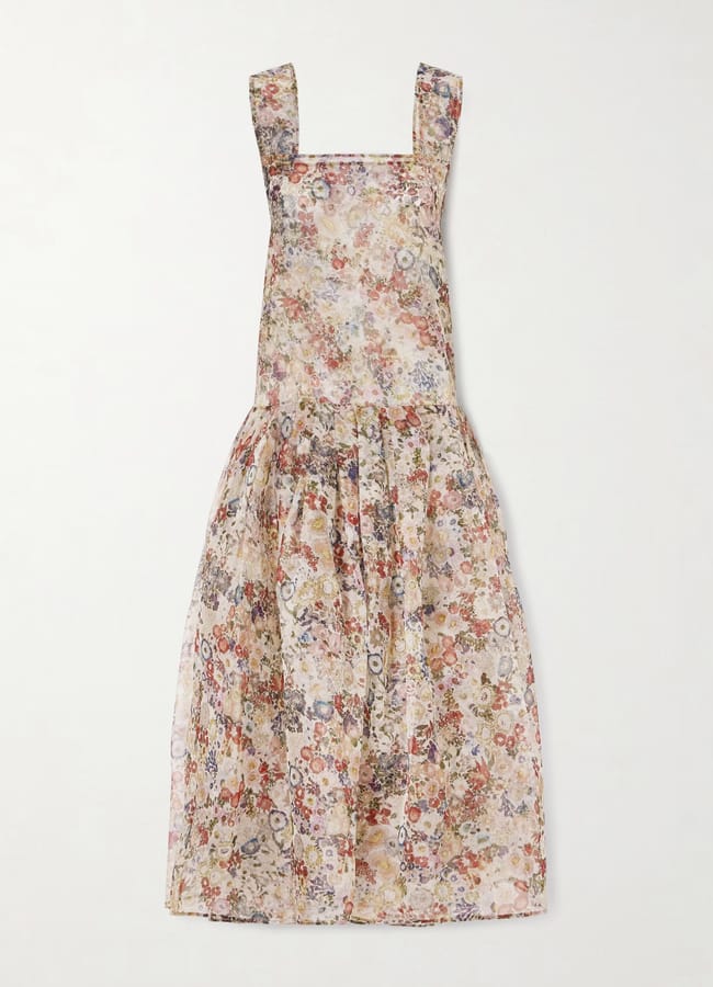 A sleeveless, square-neck midi dress with wide straps and a gathered skirt, featuring a delicate multicoloured floral print on sheer, lightweight fabric. The sheer dress is laid flat against a white background.