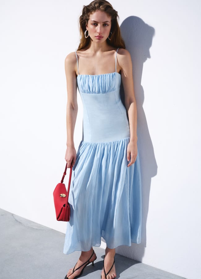 model wearing blue Mango Ruched linen dress