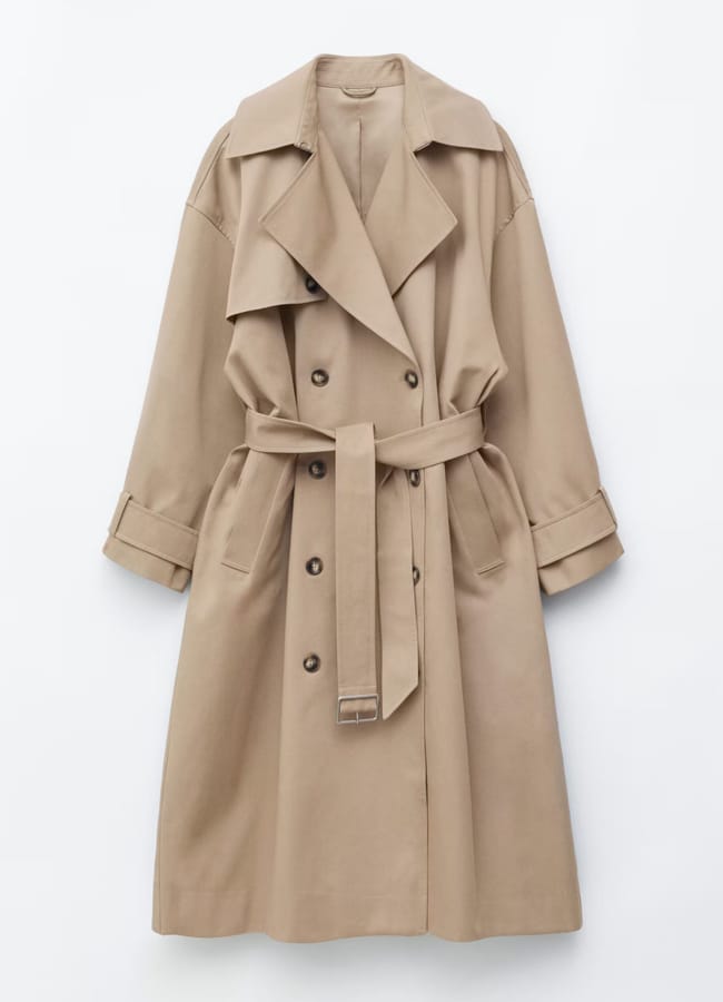 Beige double-breasted trench coat with wide lapels, a matching belt at the waist, and cuffed sleeves—an elegant choice among the best trench coats—displayed on a plain white background.