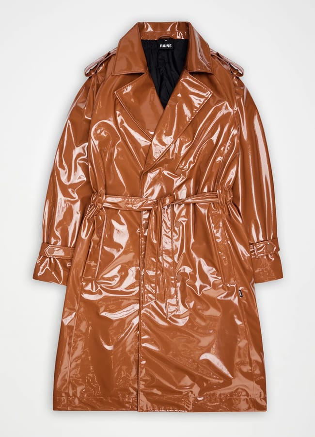A shiny, brown, vinyl trench coat with a belted waist, wide lapels, and buttoned cuffs, laid flat on a white background—a standout among stylish waterproof jackets.