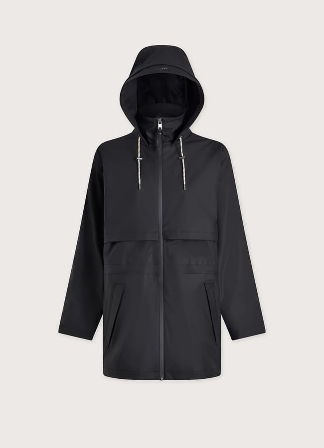 A stylish waterproof jacket, this black hooded raincoat features a front zip, adjustable drawstrings on the hood, two side pockets, and a chest flap detail, all showcased on a plain light background.