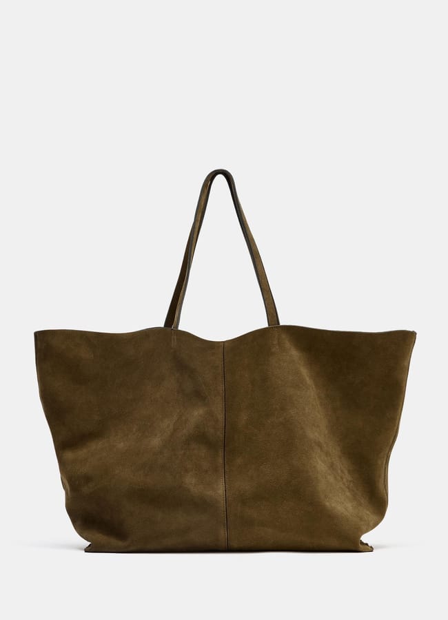 A large, olive green suede tote bag with two long handles, perfect for those who love big bags, displayed upright against a plain white background.