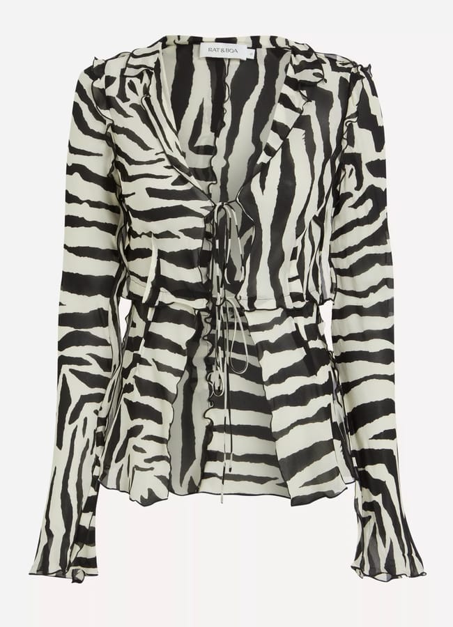 A long-sleeve, sheer blouse with a bold zebra print pattern, featuring a deep V-neckline and stylish front tie fastenings.