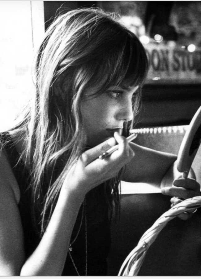 black and white photo of jane birkin looking in the mirror