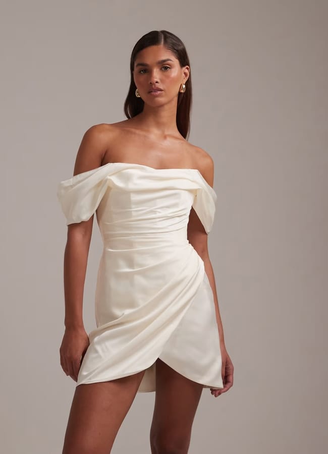 model wearing ASOS DESIGN satin off shoulder mini dress in ivory
