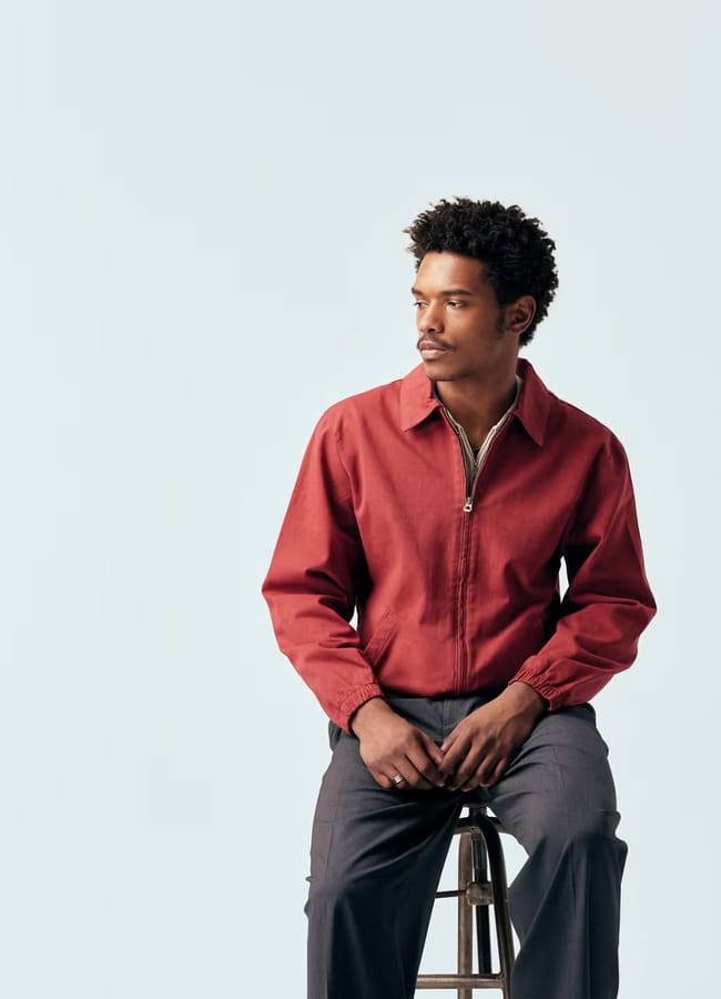 male model on stool wearing red harrington jacket