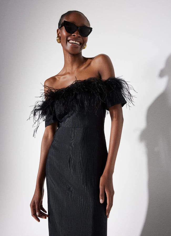 model wearing black Kitri Vivien Black Feather Midi Dress