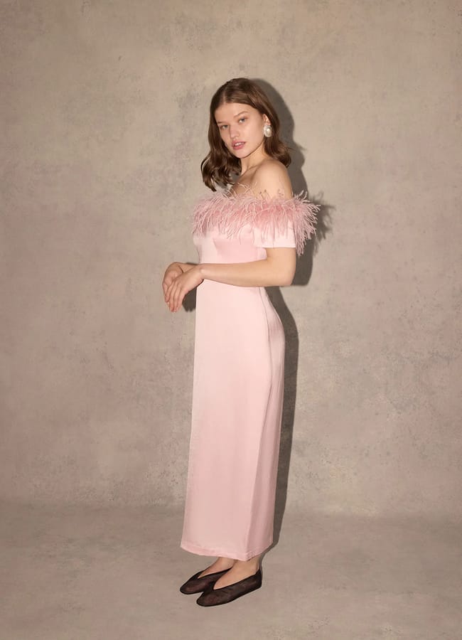 model wearing Kitri Vivien Pink Feather Midi Dress