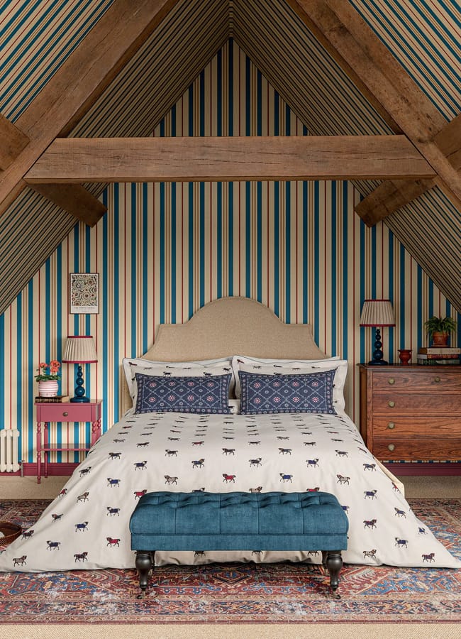 bedroom with attic ceiling, striped wallpaper and bed with Pure Cotton Dressage Horses Bedding Set