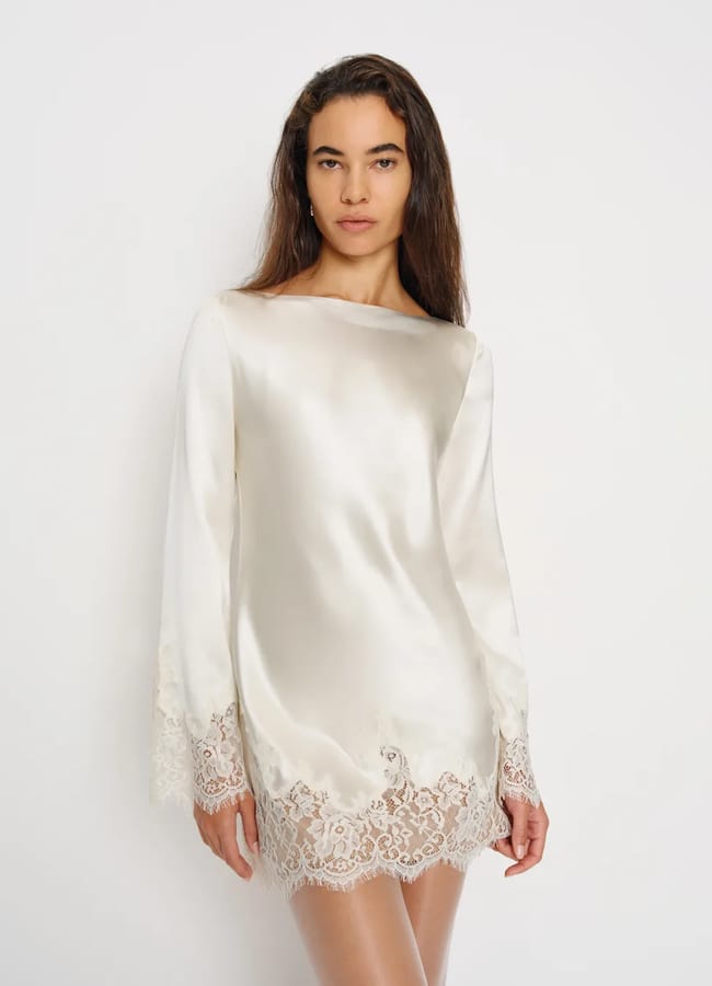 model wearing silk long sleeve mini dress with lace trim detail