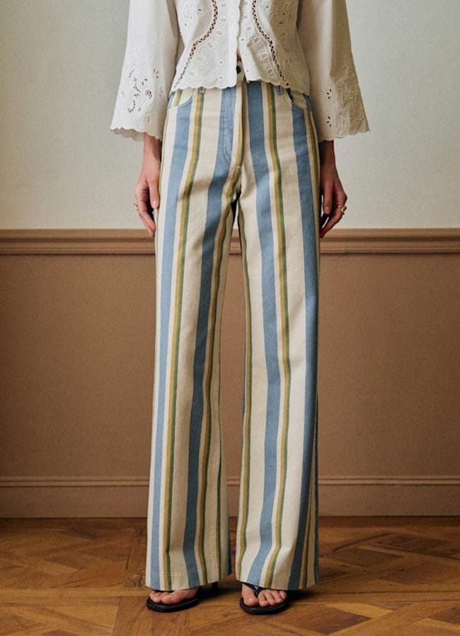 model's legs wearing blue and yellow striped trousers