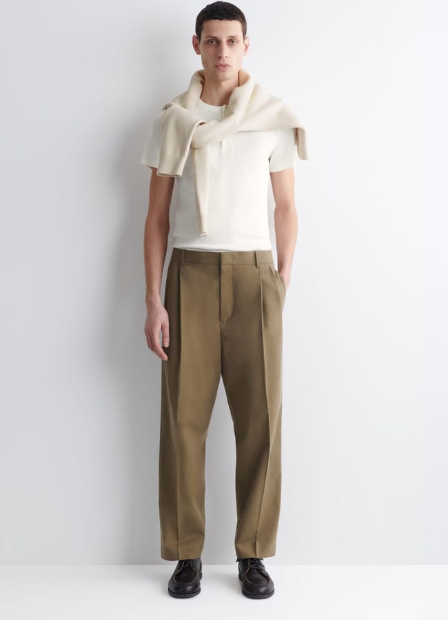 male model wearing cream shirt and Cos PLEATED RELAXED-FIT TAPERED TROUSERS