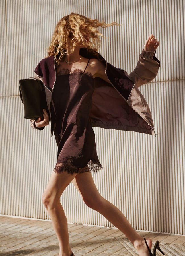 model running with arms in air wearing brown slip dress and heels