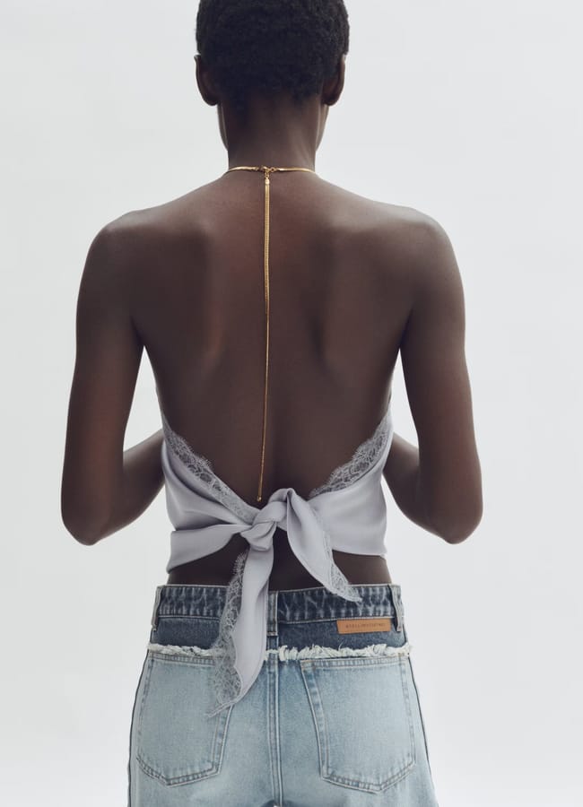 model's back wearing chain detail and tie back top