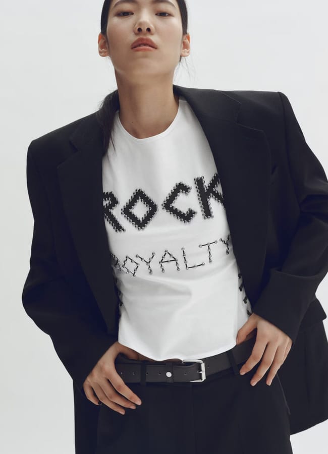 model wearing white tee with rock royalty studs