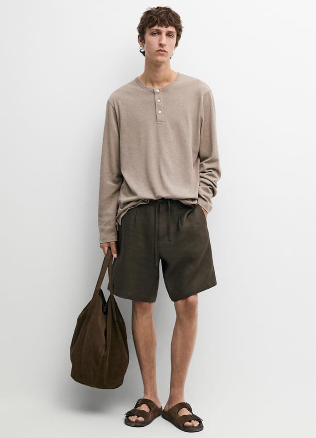 model wearing biscuit MD Long sleeve henley neck T-shirt and brown shorts