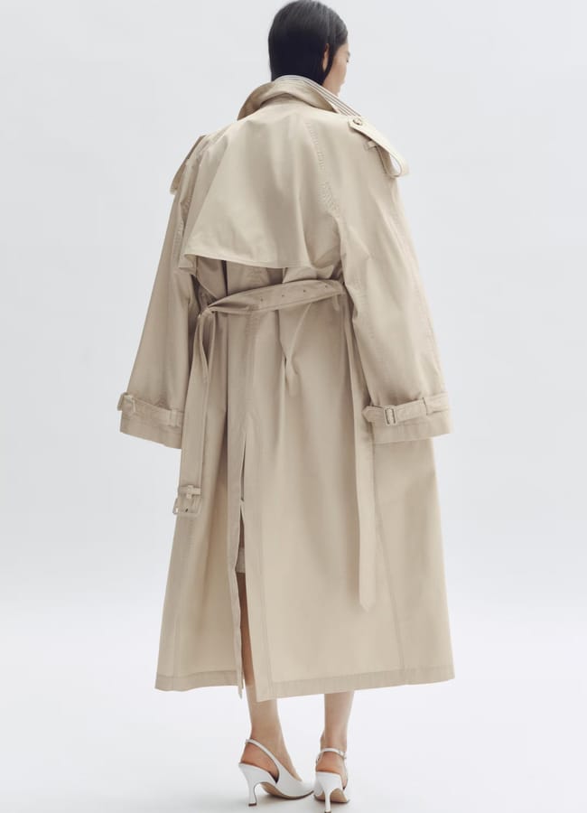 model with turned back wearing oversized trench coat