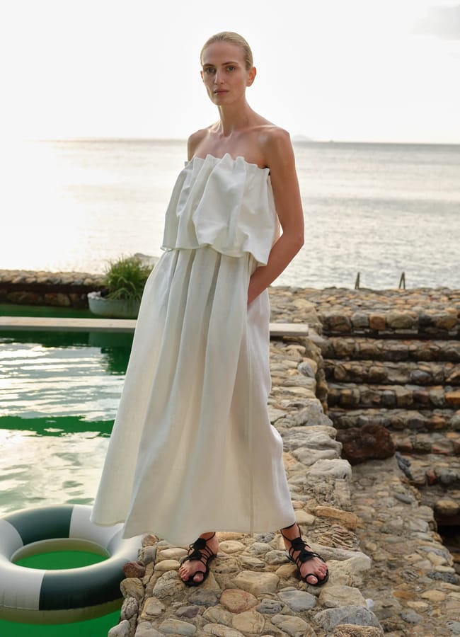 model wearing Piece of White Sadie Dress by pool