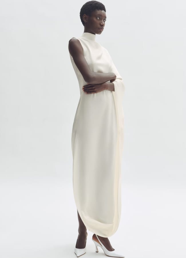 model wearing white Satin cape dress