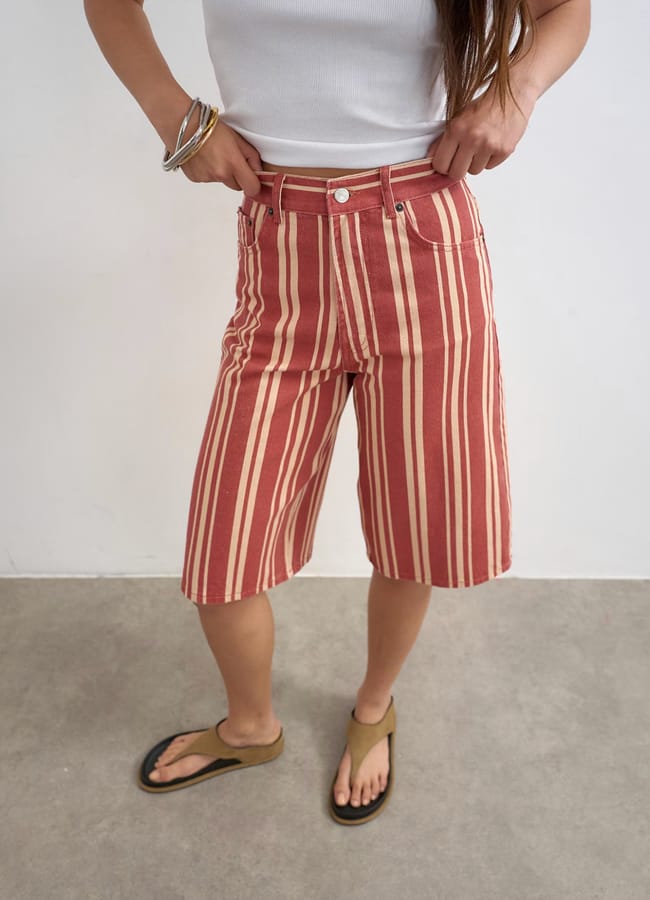 close up of model's legs wearing Topshop Denim bermuda short in red stripe