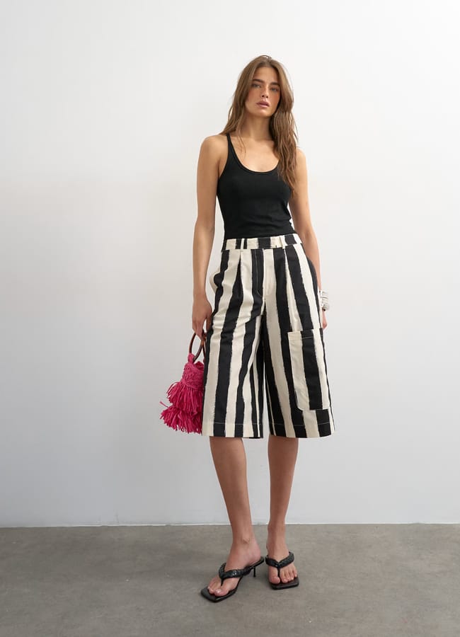 model wearing topshpo Longline bermuda cargo short in mono stripe