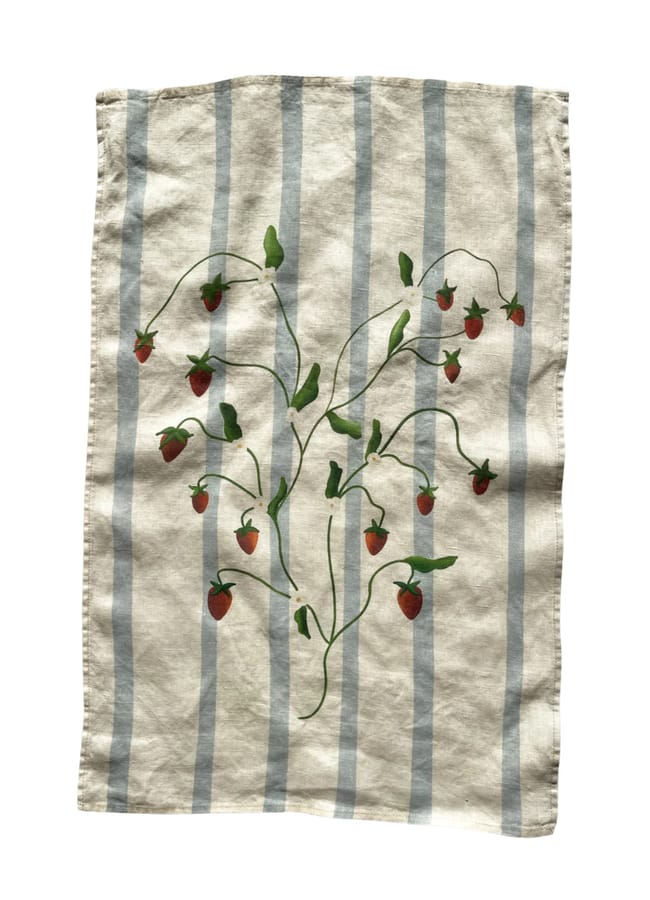 A beige cloth with vertical blue stripes and a pattern of green vines with red strawberries scattered across the centre.