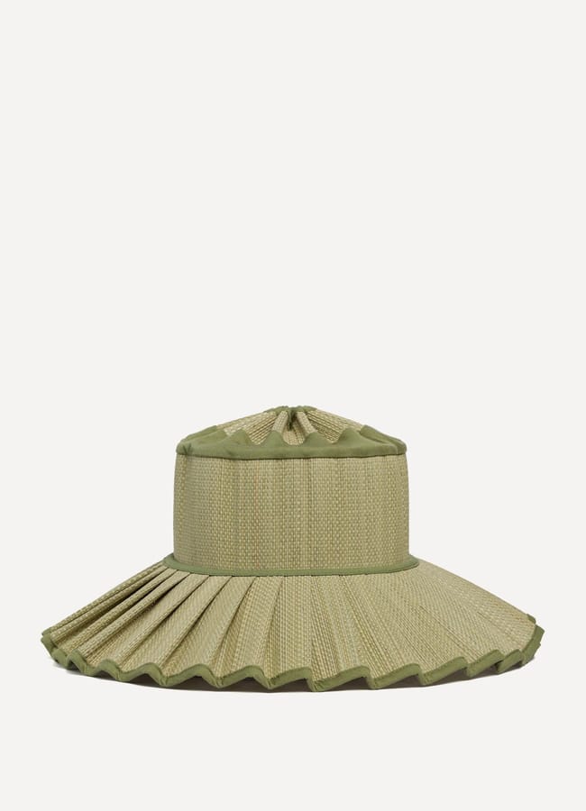 A light green sun hat with a wide, pleated brim and a rounded crown, trimmed with matching green fabric accents. A fashion opinion: this chic alternative proves you don't need banned fascinators to make a statement. The background is plain white.
