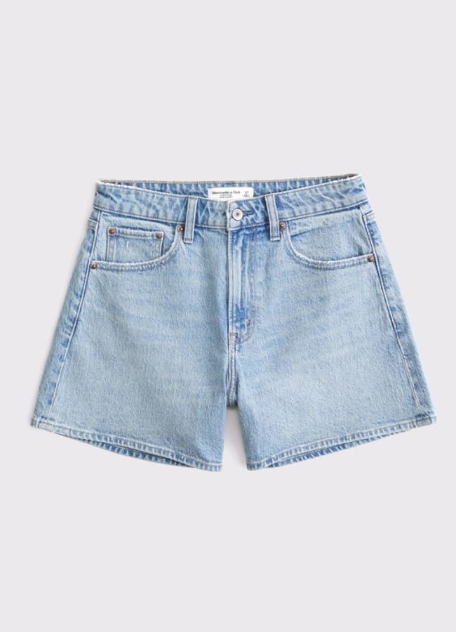 Light blue denim shorts with a high waist, button and zip fastening, belt loops, and front and back pockets—these are the best denim shorts for effortless style, displayed on a plain light background.
