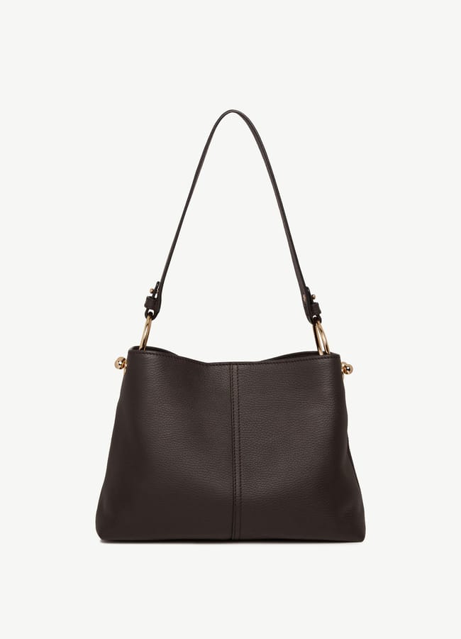A black leather designer bag with a single shoulder strap, gold fittings, and a simple, sleek design is showcased against a plain white background—a must-have accessory for any fashion editor seeking high-end style.