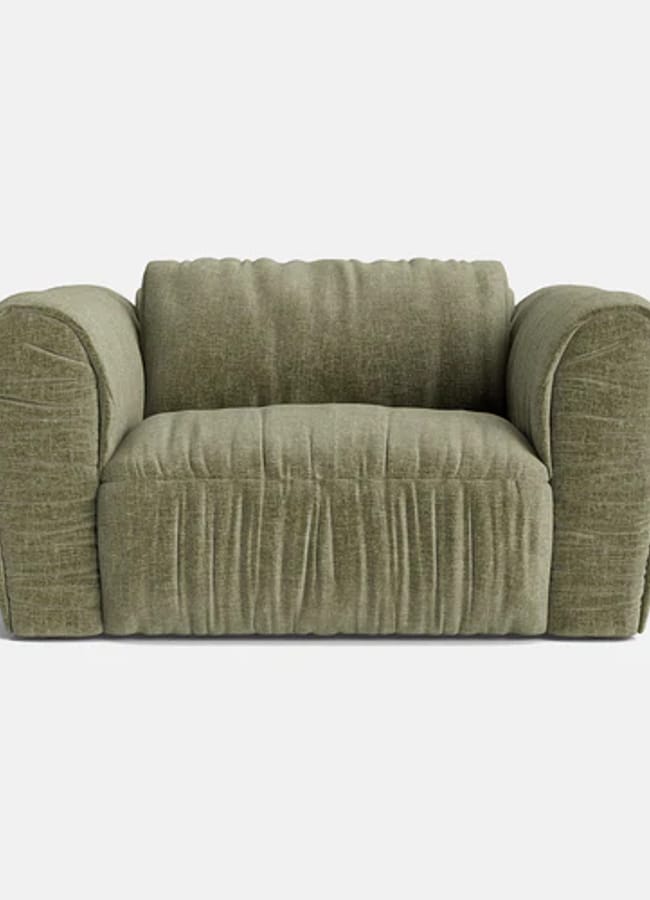 Plush, olive-green armchair with wide, rounded arms and a deep, cushioned seat, upholstered in textured fabric reminiscent of high street fashion against a plain white background.