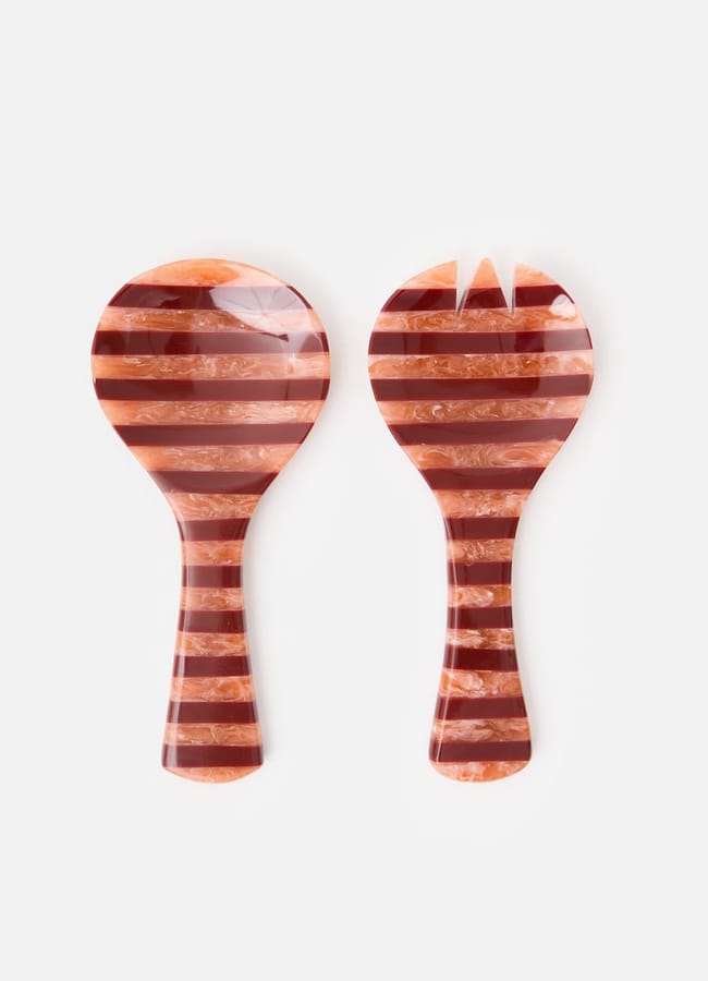 Perfect for salad season, these two salad servers feature wide, flat heads with striped patterns in shades of brown and cream. One has a solid edge whilst the other is forked, both displayed side by side on a white background.