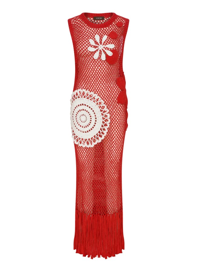 Sleeveless red crochet maxi dress with large white and red circular patterns, featuring a fringed hem and a see-through mesh design—perfect for those wondering what to wear in Ibiza.