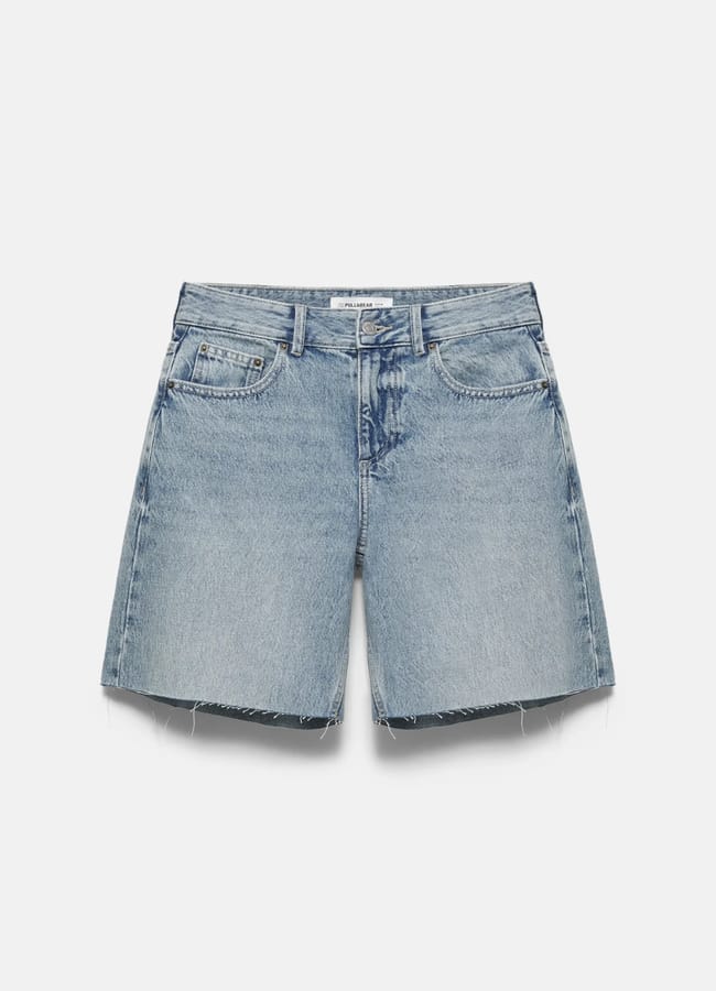 Light blue denim shorts with a classic five-pocket design, frayed hems, and a button-zip fastening—perfect for anyone searching for what to wear in Ibiza—displayed on a plain white background.