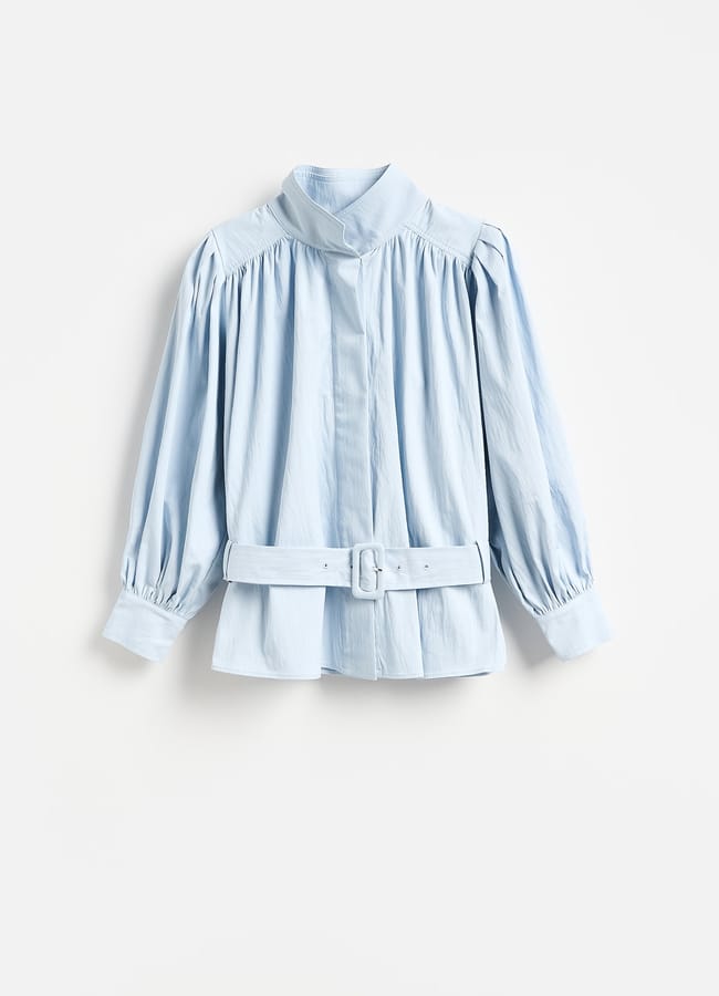 Light blue long-sleeve blouse with a high collar, gathered shoulders, buttoned cuffs, and a matching belt at the waist—an elegant piece inspired by high street fashion—displayed on a plain white background.