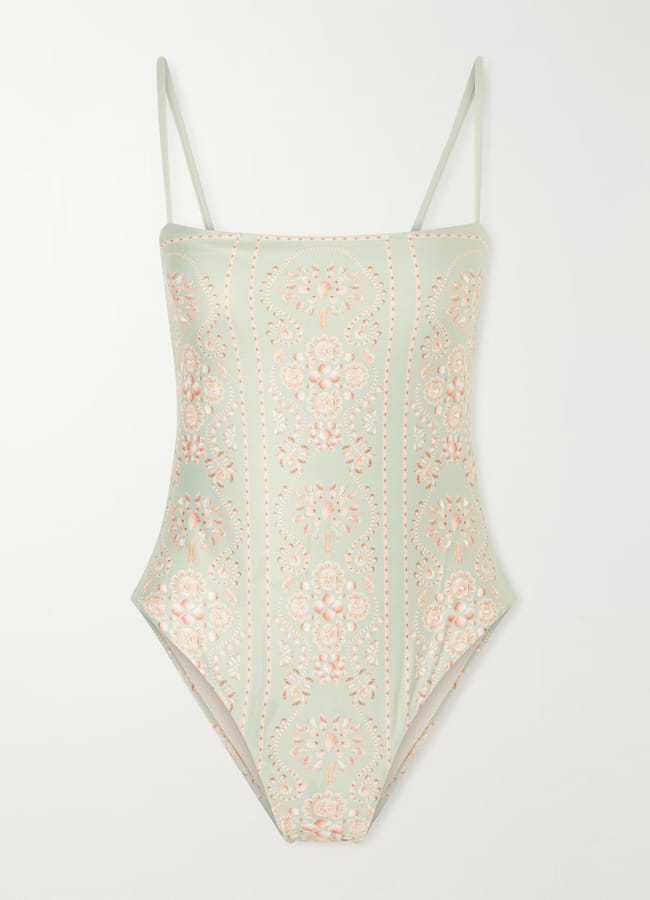 A pretty swimwear option, this one-piece swimming costume in pale green features thin shoulder straps and a delicate pink and white floral pattern arranged in vertical, symmetrical rows.