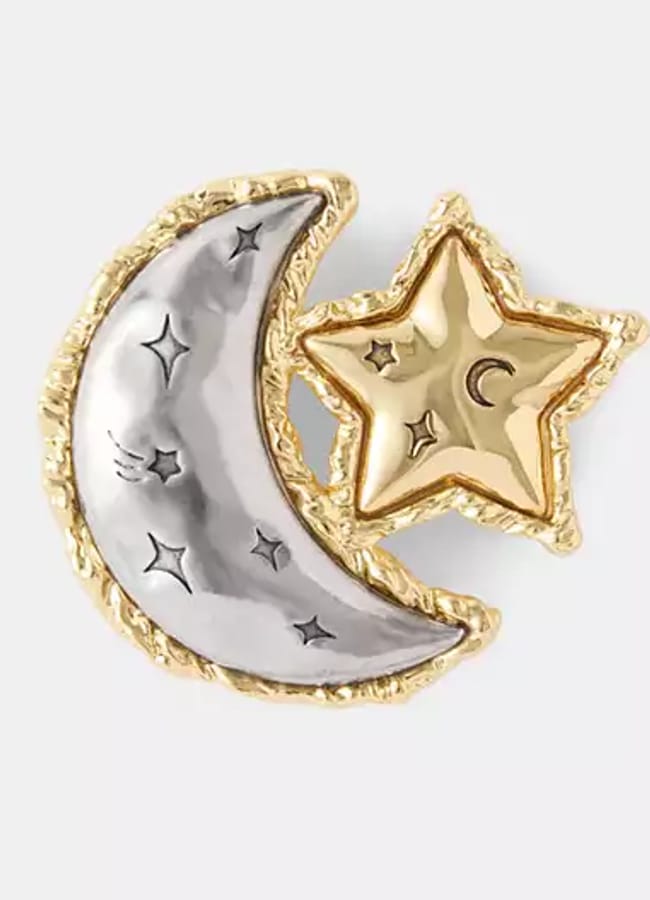 A gold-rimmed silver crescent moon with star engravings, next to a gold star embossed with a small moon and star, both on a plain white background—perfectly capturing the celestial elegance seen in autumn winter 2026 fashion trends.