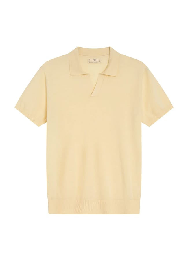 A short-sleeve, light yellow knitted polo shirt with a collar and V-neck, laid flat on a white background—an effortless nod to The Talented Mr Ripley style and the essence of refined men’s summer dressing.
